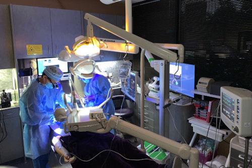 Dr. Yu & Dr. Litizzette performing surgery at office of Periodontal Surgical Arts.